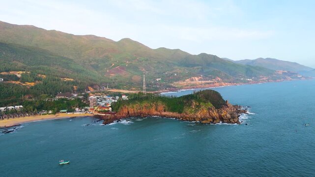 Aerial view of Bai Xep Beach's vibrant coastline, where the turquoise sea meets the sandy shore and rocky headland, Bai Xep Beach, Binh Dinh, Vietnam.