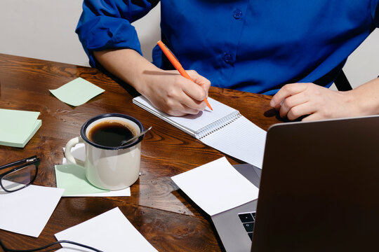 Woman working remotely at organized home office desk