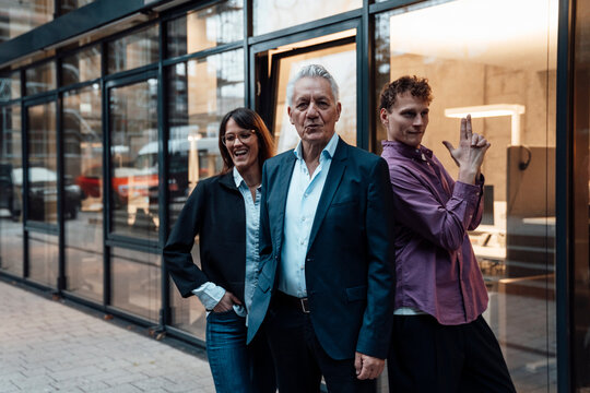 Business team taking a break outdoors in front of modern office building