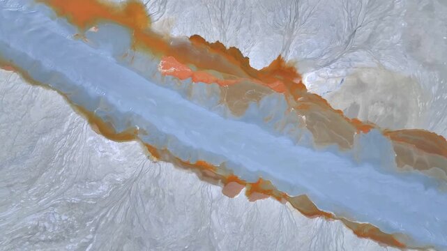 Aerial view of the vibrant red and blue waters of the Rio Tinto river flowing through the unique mineral landscape in Minas de Riotinto, Andalusia, Spain.