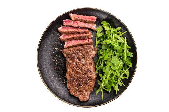 BBQ Grilled Striploin steak on a plate with salad, strip steak, prime roast beef meat isolated on white background