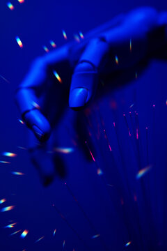 Robotic hand with fiber optics and blue cyberpunk technology theme
