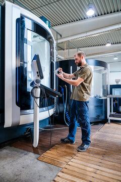 Man testing machine system in production hall