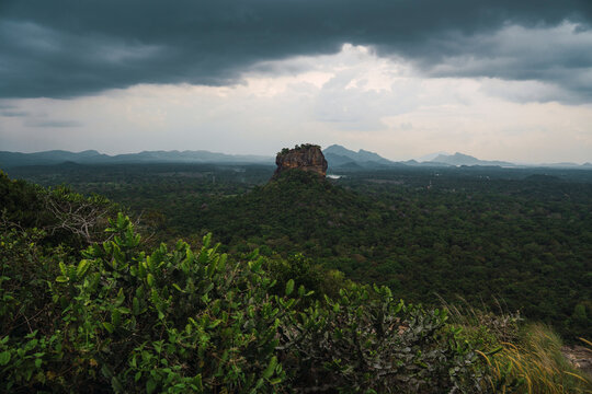 Sigiriya Lion rock and forest landscape in Sri Lanka under cloudy sky