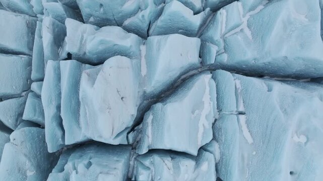 Aerial view of the textured blue ice blocks and deep crevasses of the Jokulsarlon glacier lagoon in Jokulsarlon, Sveitarfelagid Hornaf, Iceland.
