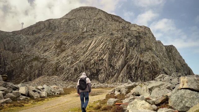 Walker at Garn For Granite Rock Mountain, Trefor Quarry, Llyn Peninsula, Gwynedd, North Wales, United Kingdom