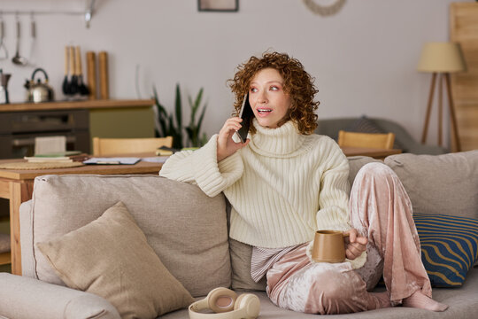Curly woman enjoying a cozy spring afternoon chat at home