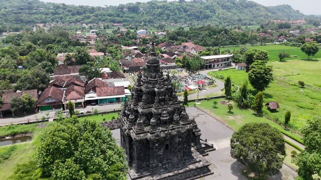 Counter-clockwise drone rotation showing the authentic stone structure of Sojiwan Temple near Yogyakarta