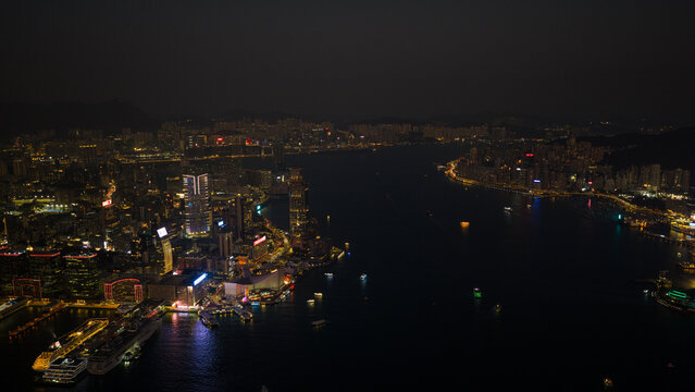 Hong Kong, Hong Kong - 13 February 2026: Aerial view of Victoria Harbour at night with illuminated skyscrapers and city lights reflecting on the water.