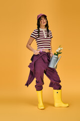 Obraz premium Young woman with pigtails finds joy in gardening while surrounded by bright colors