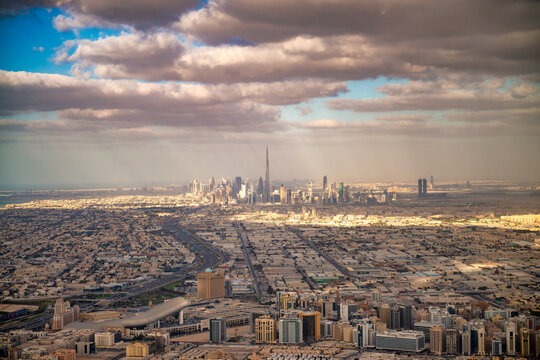 Dynamic aerial tour showcases supertall skyscrapers, and futuristic cityscape blending golden sands with glittering waterways.