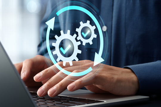 Regular system maintenance and testing for reliable and secure operation. Businessman using laptop computer to install upgrades.