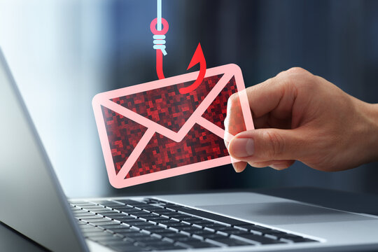 Phishing attack and scam email. Man falling victim to phishing. Spoofing and fraudulent messages arrives on laptop computer.