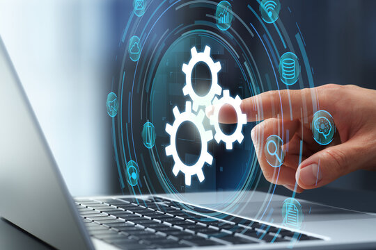 Business process automation technology. Workflow and task management solution. Businessman touching gear icon on laptop keyboard.