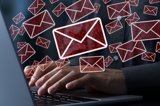 Spam emails. Spammer sending bulk mails. Phishing scam and cyber attack. Man using laptop computer.
