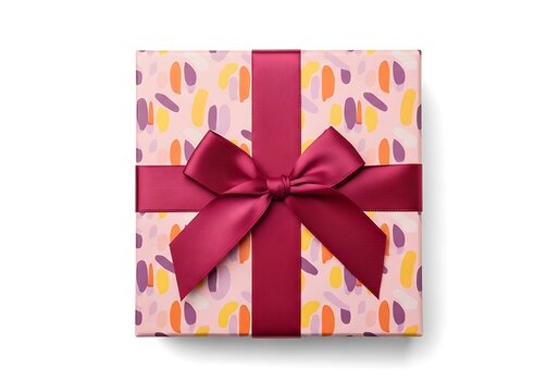 A beautifully wrapped gift box with a vibrant pink ribbon and colorful pattern on a white background