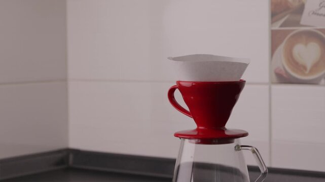 Wide shot of hands placing filter into V60 coffee dripper