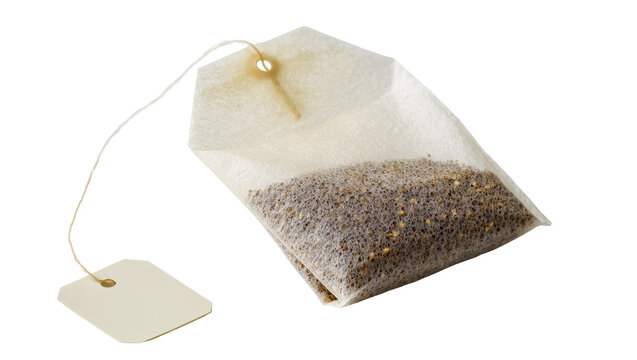 Isolated tea bag with paper label and string, filled with dry granules for a hot drink.