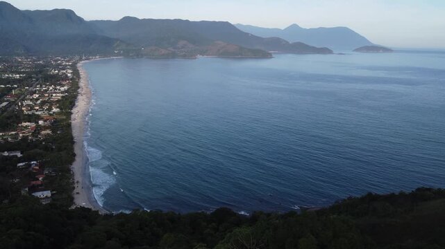 Aerial 4K wide view of Maresias beach coastline and mountains in Sao Sebastiao, Brazil