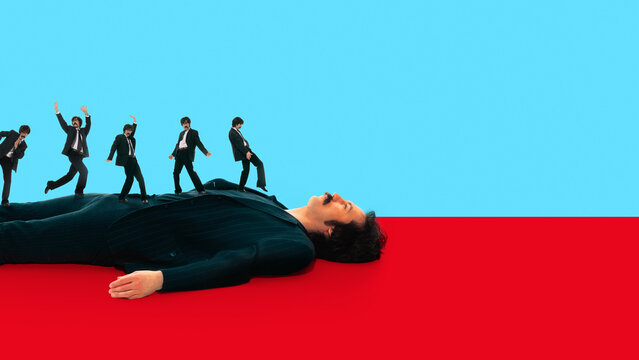 Businessman lying while multiple clones move chaotically across his body on bright background. Concept of burnout chaos, stress overload, loss of control, and mental fatigue in modern work environment