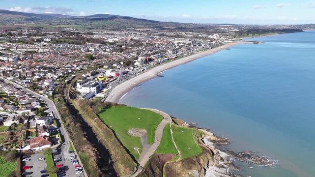 Picturesque Bray Town on Irish Coast, Drone pull back, sunny day. Popular scenic spot.