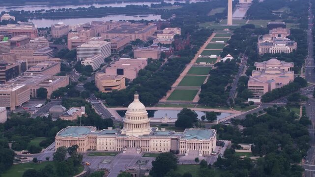 Drone footage of Washington, D.C. showcasing the United States Capitol building with its iconic dome and neoclassical architecture. The aerial view extends across the National Mall.