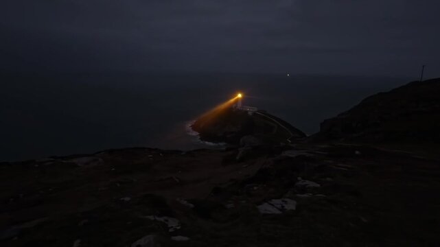 South Stack lighthouse time lapse rotating beacon light beam across the Irish sea at night