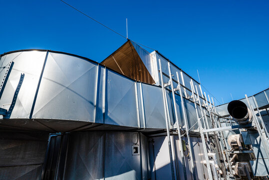 Industrial HVAC ventilation system with large air ducts on rooftop facility
