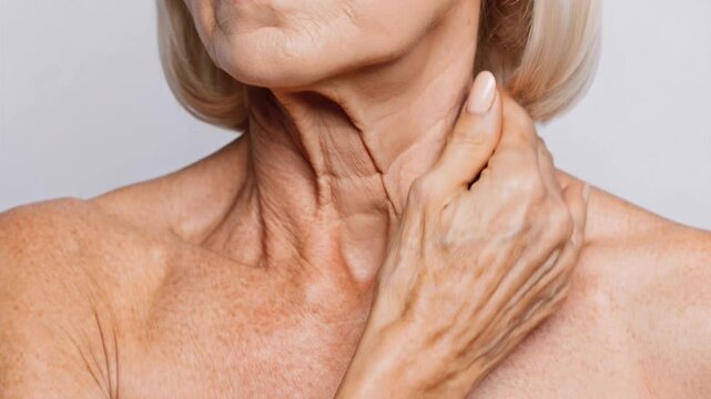 Close up of an older woman&rsquo;s neck showing wrinkles and skin aging concerns.