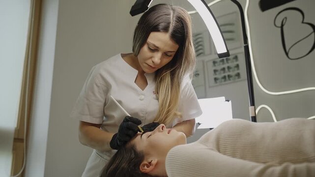 Eyebrow microblading treatment in progress at beauty clinic