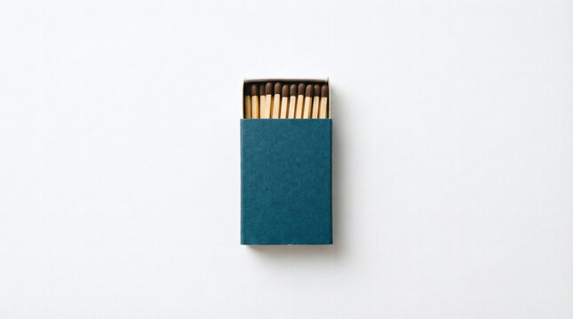 Matchbox Still Life Dark blue box with brown matches on clean white.