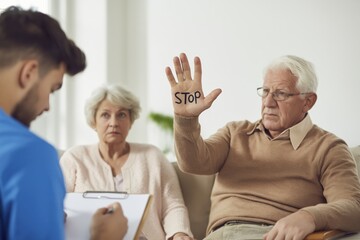 Fototapeta premium Senior Couple Shows STOP Hand to Male Nurse During Consultation