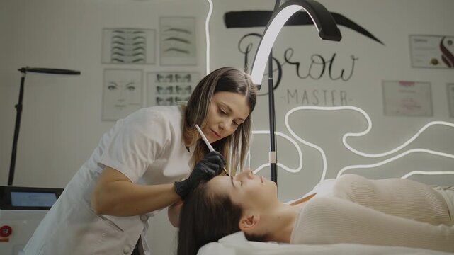 Close-up of microblading eyebrow procedure in beauty salon
