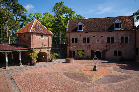View of the historic red brick buildings and star-patterned courtyard of Fort Zeelandia under a clear blue sky in Paramaribo, Paramaribo District, Suriname.