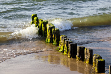 Worn breakwaters are found on the Baltic Sea coast in Ustronie Morskie in Poland © marek_usz