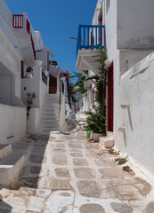 Fototapeta premium Tourists relax on the streets of Chora among shops and restaurants on the island of Mykonos in Greece.