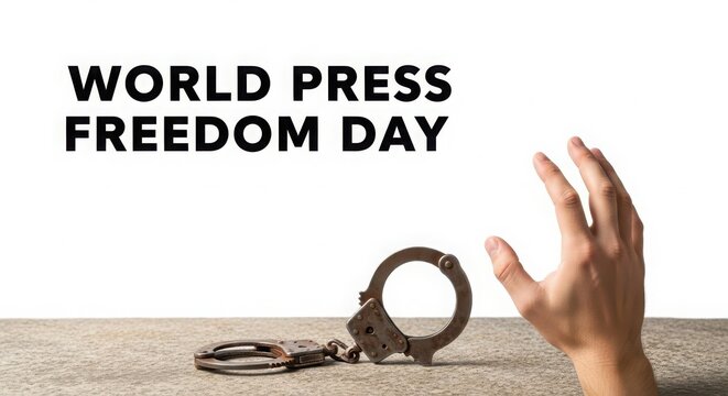 Hand reaching towards unchained handcuffs on world press freedom day