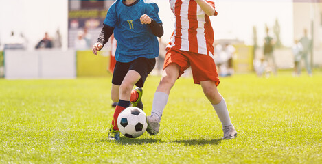 Boys Running with Ball on Sunny Outdoor Football Field. Youth Soccer Game Action. Soccer Tournament For Kids © matimix