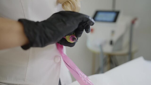 Preparing pigment for microblading eyebrow procedure in beauty clinic