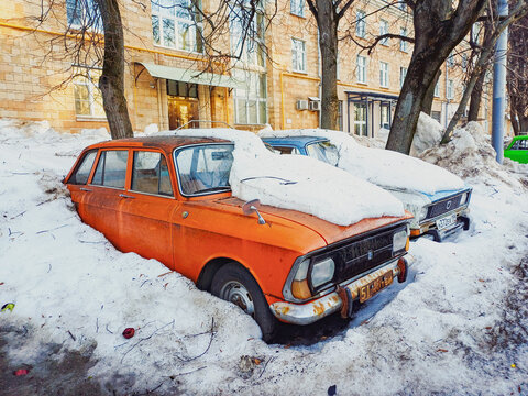 Moscow, Russia - February 25, 2026: Vintage soviet moskvitch and izh cars buried under deep snow in moscow courtyard