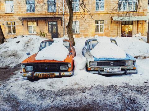 Moscow, Russia - February 25, 2026: Two vintage soviet moskvitch cars covered with snow in moscow courtyard