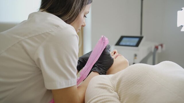 Close-up of microblading eyebrow procedure in clinic