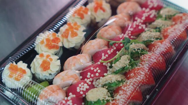 Sushi set. Japanese food. Different types of sushi beautifully arranged in plastic packaging. Different sushi in the set. Colorful colors and flavors.
