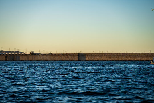 Reservoir dam wall with rippled water at sunset