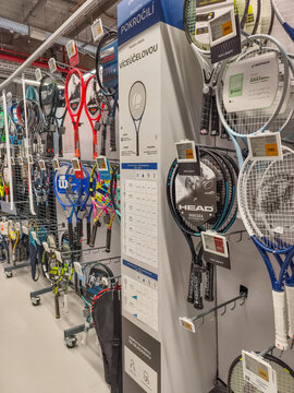 Prague, Czech Republic - March 31, 2026: Interior of a sporting goods store with a large display of tennis rackets and sports equipment in Prague.