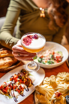Gourmet dining with cocktail and assorted dishes on table