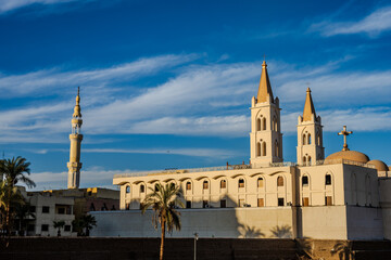 Fototapeta premium Church and mosque towers under blue sky
