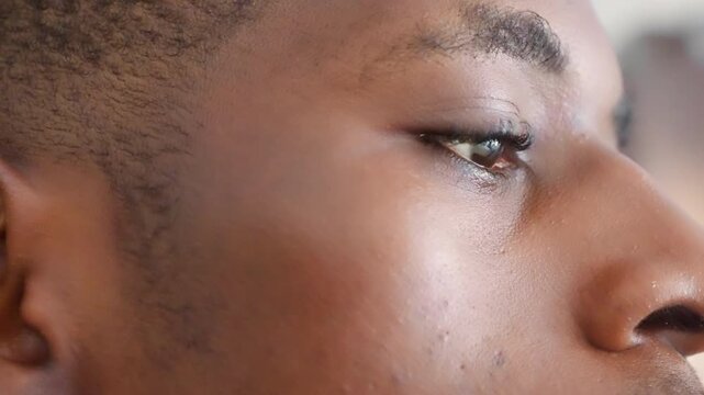 Black male profile closeup showing contemplative gaze. Subtle tear, textured skin, soft studio light and cinematic framing. Fiveframe sequence presents model as art student, actor, poet, musician