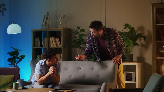 Annoyed father scolding his teen son for skipping school lessons, parenting
