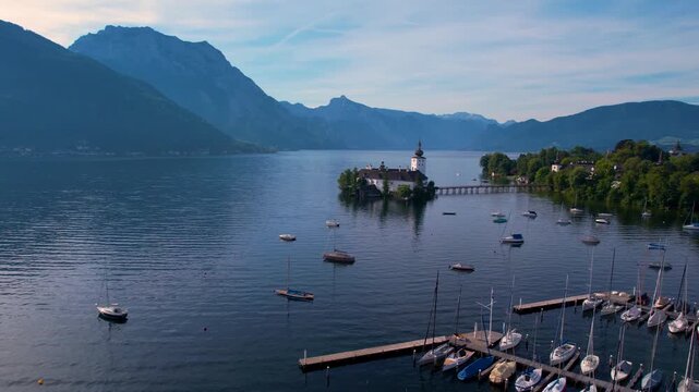 Schloss Ort Castle Austria Drone Video, Aerial View Flying over Sailing Boats towards White Island Fortress on Traunsee Lake, Scenic Alpine Mountains Landscape at Morning Light, Gmunden Salzkammergut 
